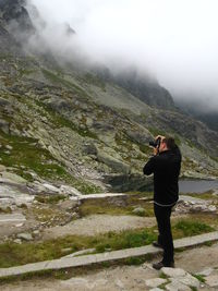 Full length of man photographing on mountain