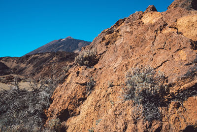 Scenic view of rocky mountains against clear blue sky