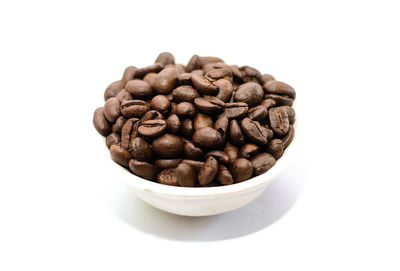 Close-up of coffee beans against white background