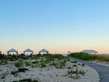 Scenic view of beach against clear sky during sunset