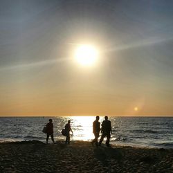 People on beach at sunset