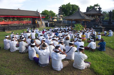 Group of people at temple against building