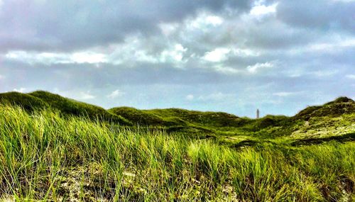 Scenic view of landscape against cloudy sky