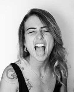 Portrait of young woman against white background