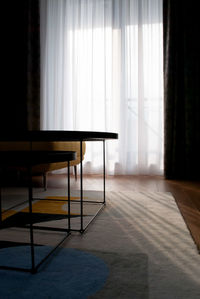 Empty chairs and table in room