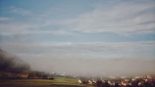 Panoramic view of buildings in city against sky