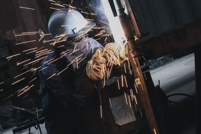 Welder welding in workshop