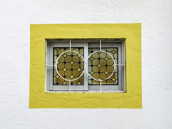 Yellow window on wall