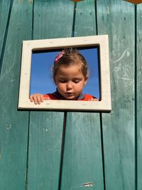 Girl peeking through window