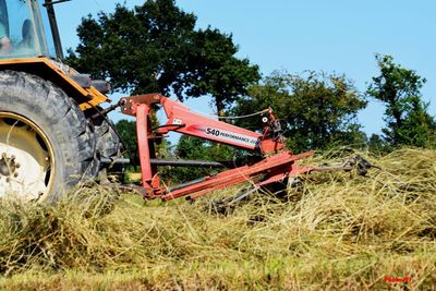 Abandoned tractor on field against clear sky