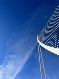 Low angle view of the bridge, against blue sky. ciutat de les arts i les ciéncies, valència.