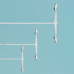 Low angle view of pole against clear blue sky