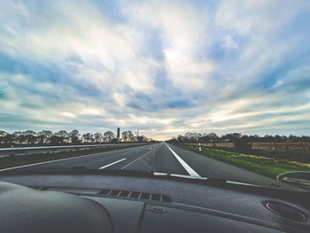 Road against sky seen through car windshield