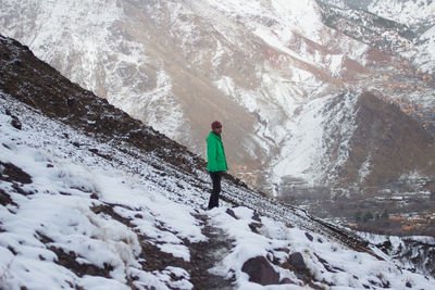 High angle view of man standing on snowy mountain