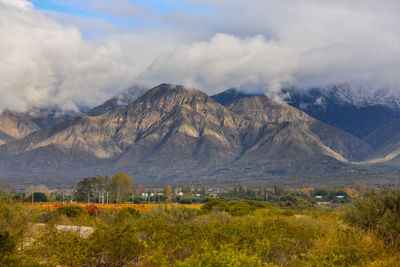Scenic view of mountains against cloudy sky