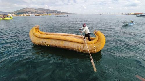 Man in sea against sky