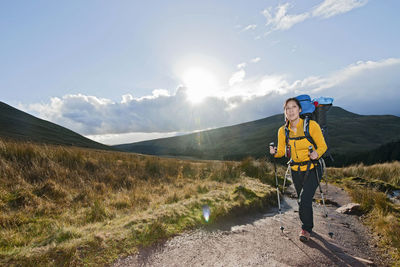 Full length of man standing on mountain against sky