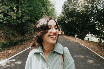 Portrait of young woman standing in forest