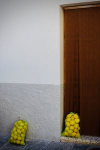 Yellow fruits on table against wall at home