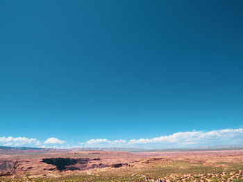 Scenic view of desert against blue sky