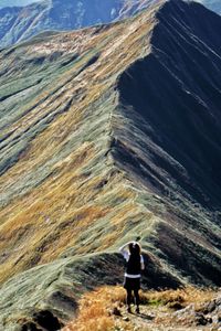 Rear view of woman walking on mountain