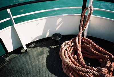 High angle view of rope tied in boat moored at harbor