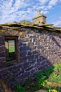 Low angle view of old building against sky