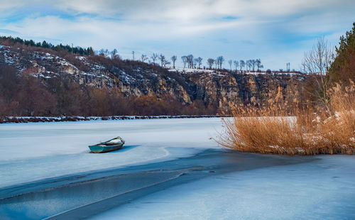 Old fishing boat frozen in the ice, rusenski lom canyon, ruse district, bulgaria