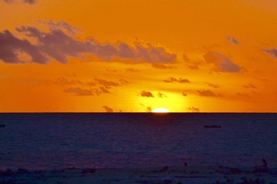 Scenic view of sea against orange sky