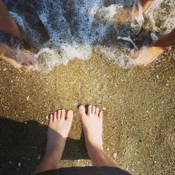 Low section of woman standing on beach