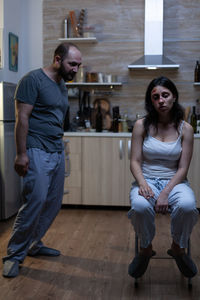 Young couple sitting on floor at home