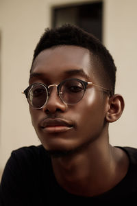 Close-up portrait of young man wearing sunglasses