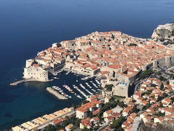 High angle view of townscape by sea