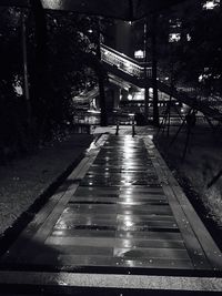 Illuminated bridge in city against sky at night