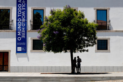 Full length of people walking by building