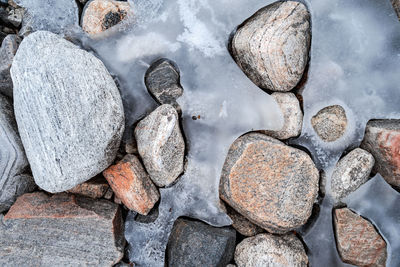 High angle view of stones on snow