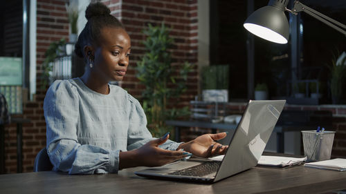 Young businesswoman using laptop at office