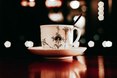 Porcelain teacup on table against defocused background