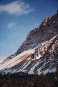 Low angle view of snowcapped mountain against sky