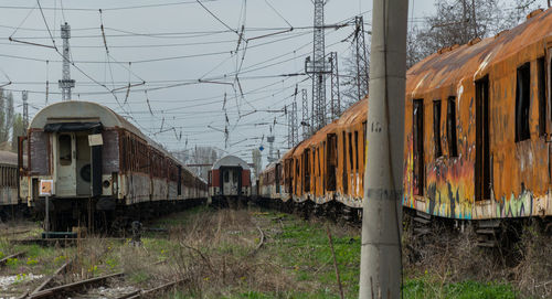 Train on railroad track amidst field against sky