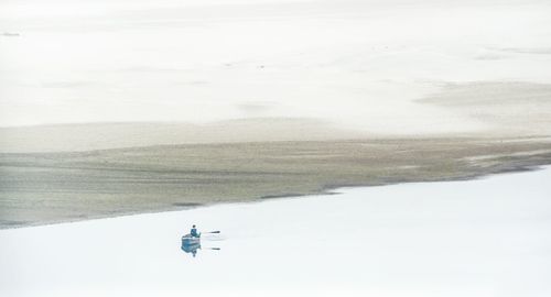 Man on snow covered landscape against sky