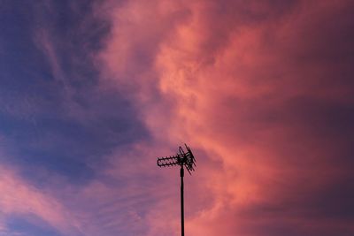 Low angle view of silhouette crane against sky during sunset