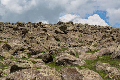 Low angle view of rock formation against sky