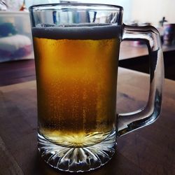 Close-up of beer glass on table