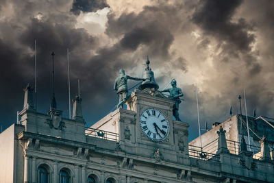 Low angle view of clock tower against sky