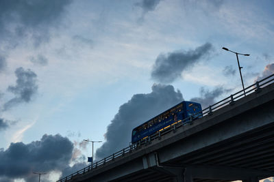 Low angle view of bridge and buildings against sky