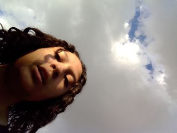 Close-up portrait of woman against sky