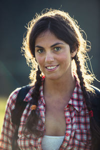 Portrait of smiling young woman standing outdoors