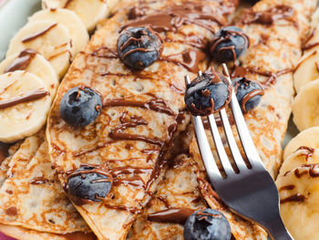 Delicious crepes filled with chocolate hazelnut spread and topped with banana and blueberries. 