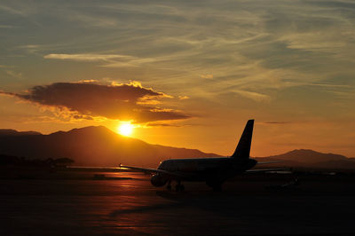 Silhouette of airplane at sunset